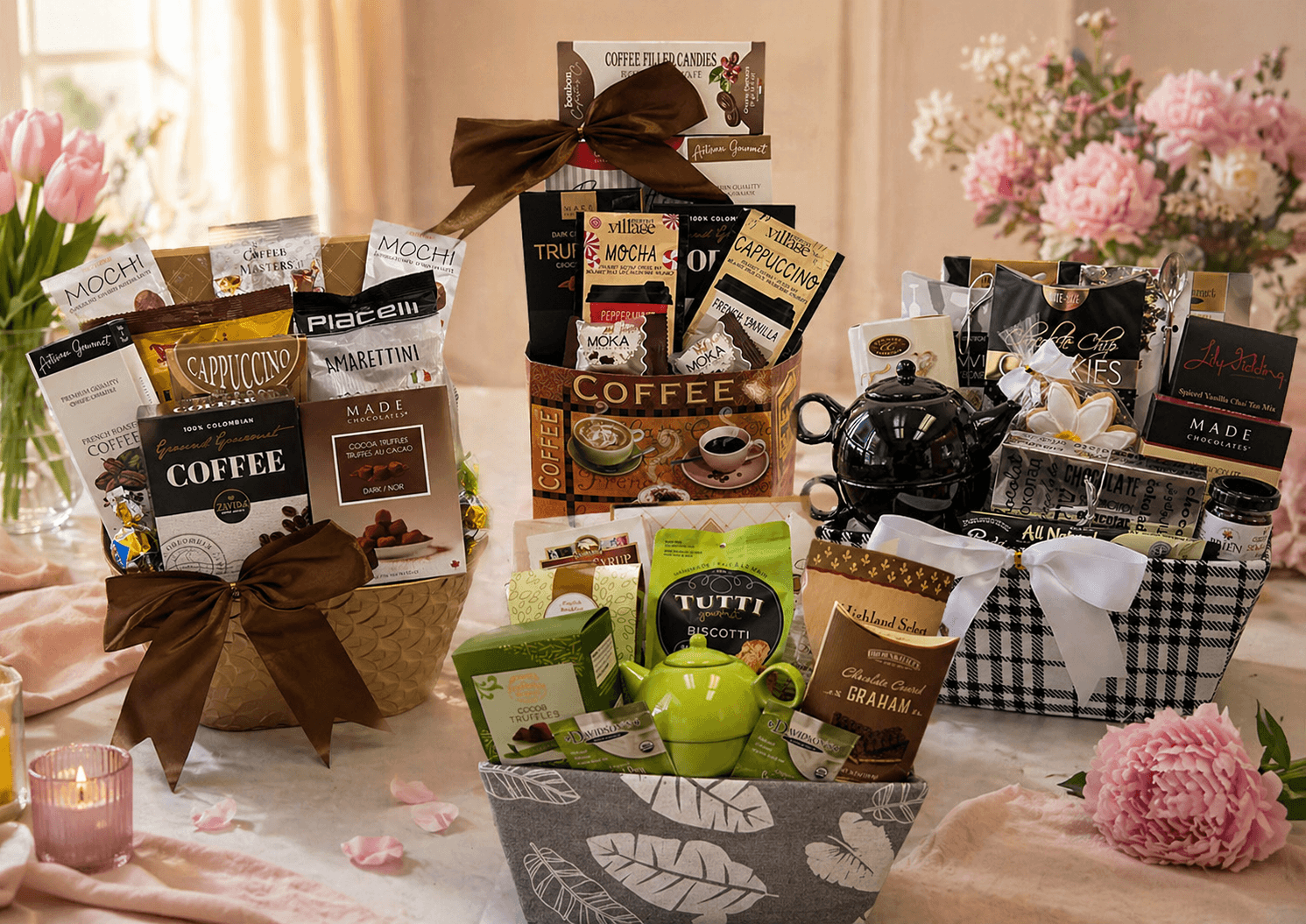 Gourmet gift basket with coffee, tea, and snacks on a table with flowers and candles.